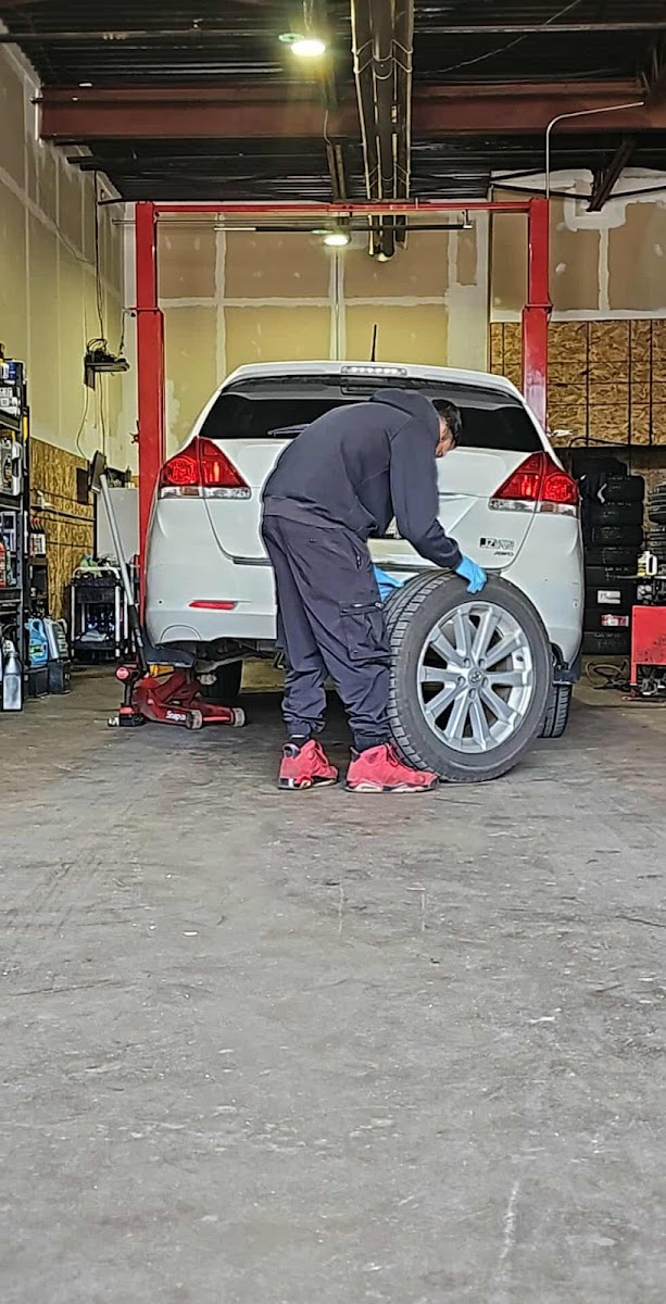 The Iron Street sign and bay door of High Quality Auto Service.